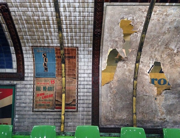 cladding reveals old posters at Trinite metro